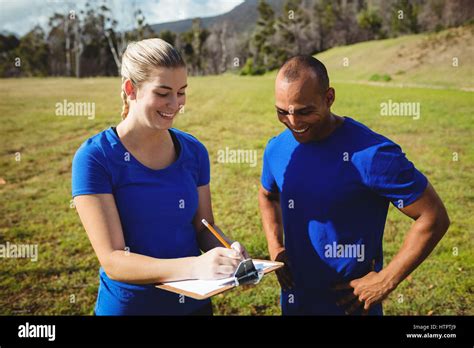 Female Trainer Instructing A Man In Bootcamp Stock Photo Alamy