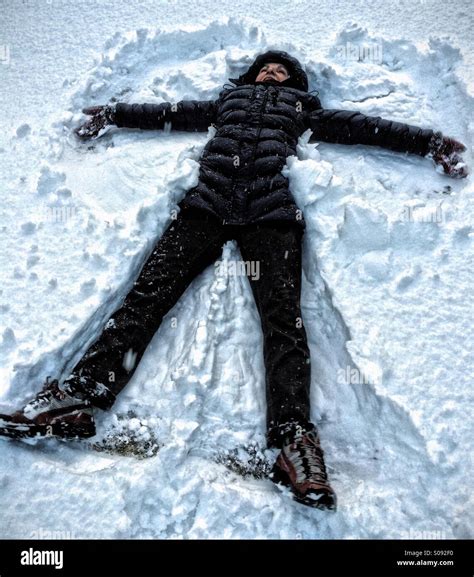 An Adult Woman Making Snow Angels Stock Photo Alamy