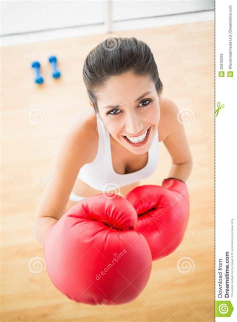 Fit Woman Wearing Red Boxing Gloves Smiling At Camera