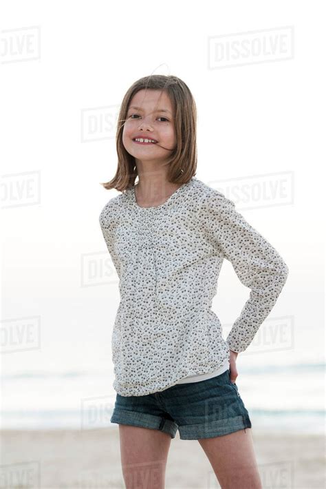Girl Standing On Beach Smiling Portrait Stock Photo Dissolve