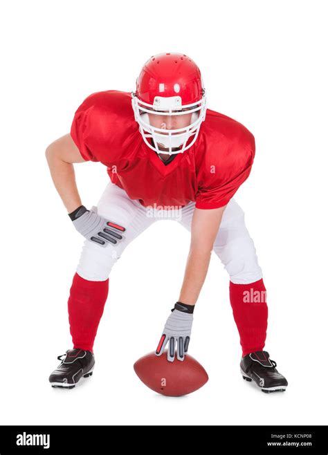 American Football Player With Rugby In Pose Over White Background Stock