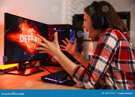 Angry Girl Gamer Sitting At The Table Playing Online Games Stock Image