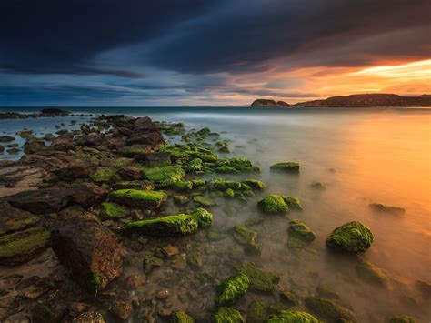 Sunset In Spain Coast Rocks With Green Moss Sea Reflection On Red Sky In Water Hd Wallpapers For