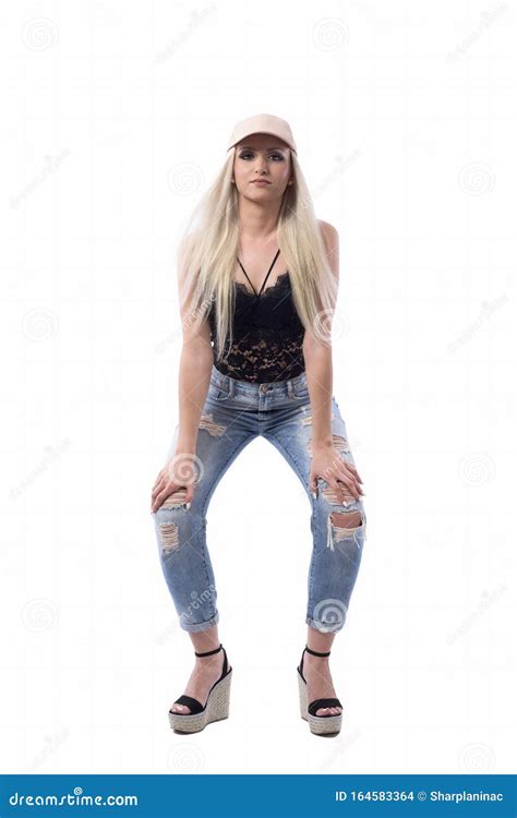 Confident Modern Cocky Young Blonde Girl In Trendy Look Leaning And Posing With Hands On Knees