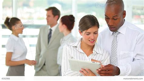 Two Business People Working Together On A Tablet Stock Video Footage
