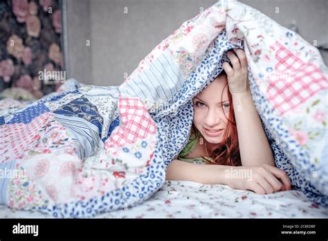Beautiful Woman Lying Under Duvet In Bed At Home Stock Photo Alamy