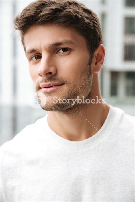 Close Up Portrait Of A Handsome Young Man Looking At Camera While