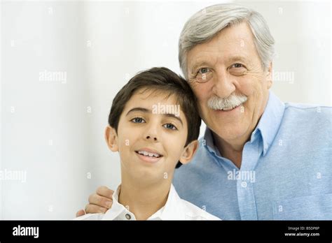 Grandfather And Grandson Smiling At Camera Portrait Stock Photo Alamy