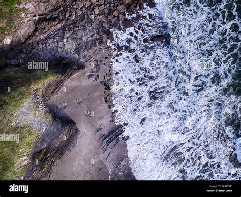 Cornwall Beach With Foaming Waves Crashing On Rocks Aerial Photo Stock