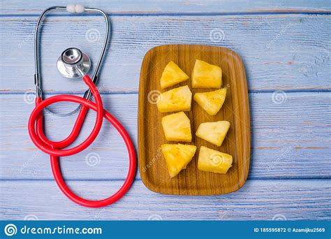 Pineapple Sliced And Stethoscope On Wooden Background Care And