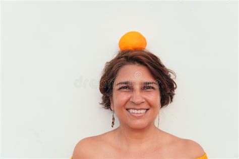 Mujer Latina Madura Con Naranja En La Cabeza Imagen De Archivo Imagen