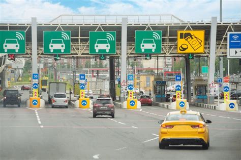 View With Cars At The Entrance Or Exit To A Toll Road Limited By A