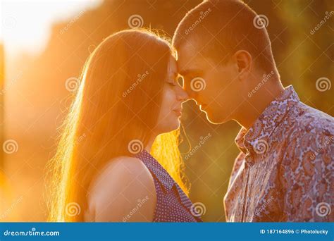 Portrait Of Brunette Woman And Man Kissing And Embracing Face To Face