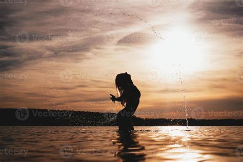 Beauty Model Girl Splashing Water With Her Hair Woman In Water