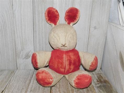 A Stuffed Animal Sitting On Top Of A Wooden Bench