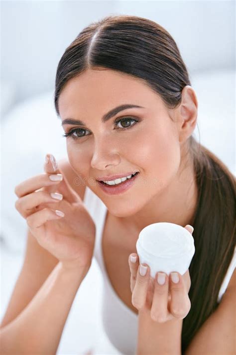 Beauty Beautiful Woman Applying Face Cream On Soft Facial Skin Stock
