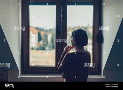Triste Mujer Mirando Por La Ventana En El Apartamento Loft Fotografía
