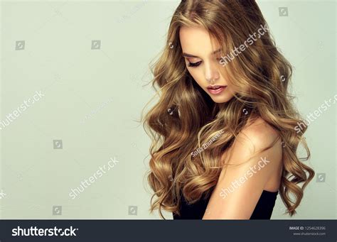 Laughing Blonde Girl With Long And Shiny Wavy Hair Beautiful Smiling Woman Model With Curly