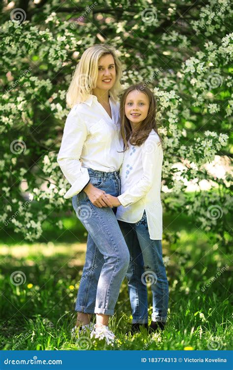 Mother And Babe In The Blooming Rose Gardens Of Apple Trees Happy