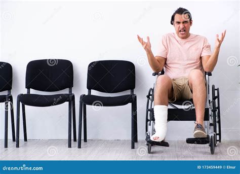 Young Injured Man Waiting For His Turn In Hospital Hall Stock Image
