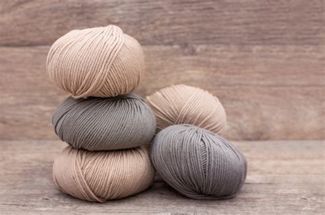 Free Photo Close Up Of Wool Knitting On Wooden Background