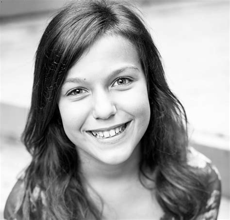 A Black And White Photo Of A Woman Smiling