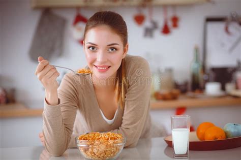 Happy Young Woman Having Healthy Breakfast In Kitchen Stock Image