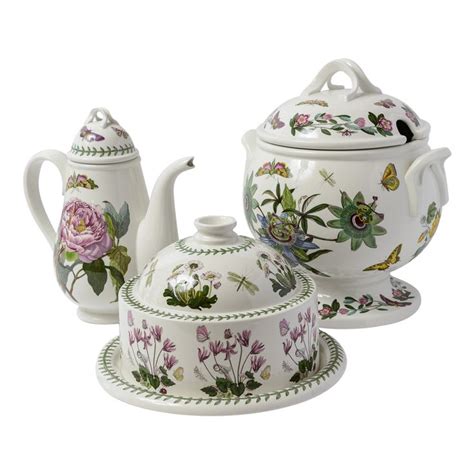 Three Pieces Of Porcelain Tea Set With Flowers On Them