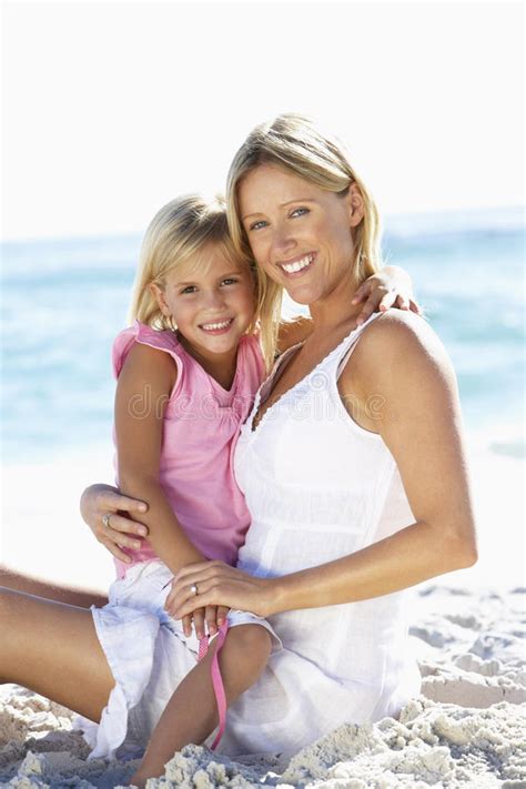 Mother And Daughter Running Along Beach Together Wearing Swimming Costume Stock Image Image Of