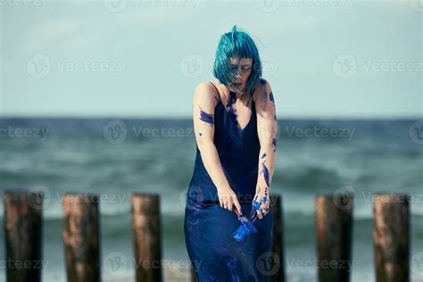 Artistic Blue Haired Woman Performance Artist In Dress Smeared With Blue Gouache Paints On Her