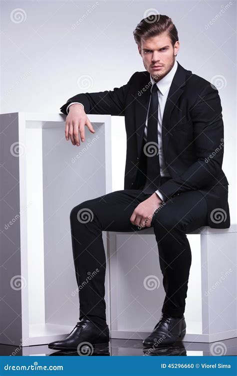 Business Man Sitting On A Chair While Resting His Hand Stock Photo