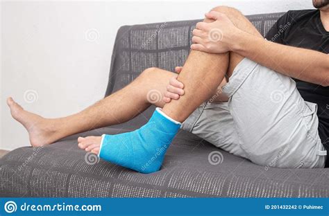 Man With Broken Leg In Blue Splint For Treatment Of Injuries From Ankle