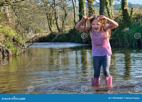 A Young Girl Dripping Wet Soaked Through Standing In The River Aeron