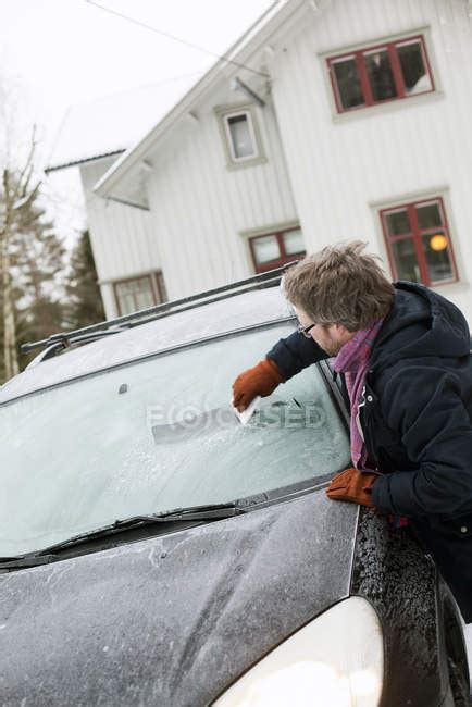 Man Scraping Ice Off Car Windshield At Winter — Cold Temperature Waist