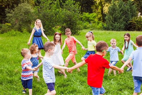 Happy Kids Dancing In Circle On Green Stock Image Colourbox