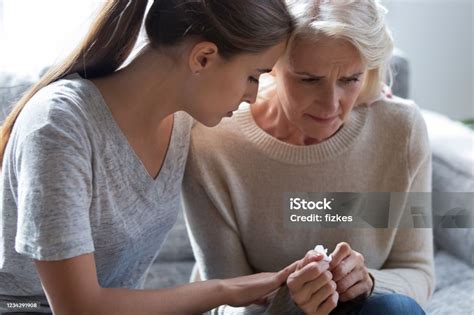 Worrying Millennial Lady Sitting Next To Upset Frustrated Mommy Stock