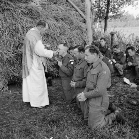 A Military Chaplain Carries Out Mass In A Field For Catholic British
