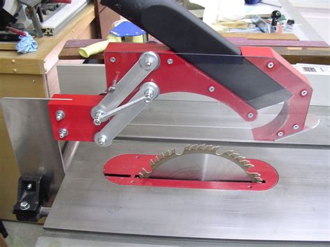 To assemble an adjustable outfeed roller for your table saw and other power tools, drill holes in the base of a scissors jack and bolt it to a sturdy sawhorse. Tablesaw blade guard with dust collection! | Table saw, Woodworking, Dust collection