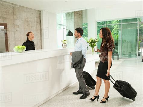 Business People Arriving At Hotel Reception Area Stock Photo Dissolve