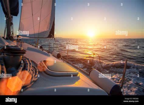 Sailing Ship Luxury Yacht Boat In The Sea During Amazing Sunset Stock