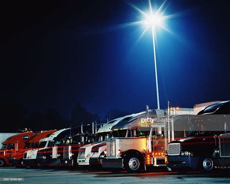 Semitrucks In Parking Lot At Night High Res Stock Photo Getty Images