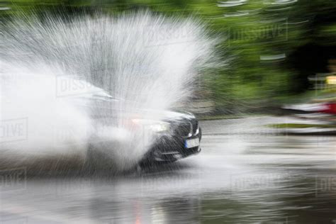 Car Splashing Water On Road Stock Photo Dissolve