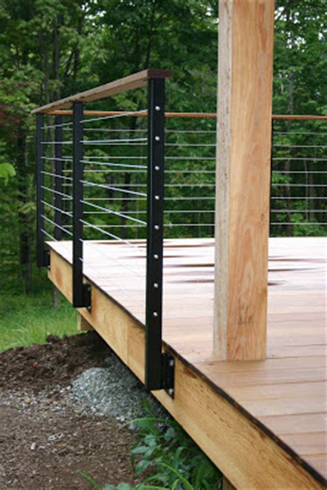 Deck railing posts are often notched at the bottom to create a lip that extends a few inches over the floor of the deck. modern cabin: deck railing
