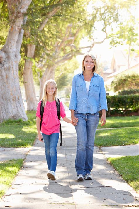 Mother And Daughter Walking To School On Suburban Street Stock Photo Image Of Backpack