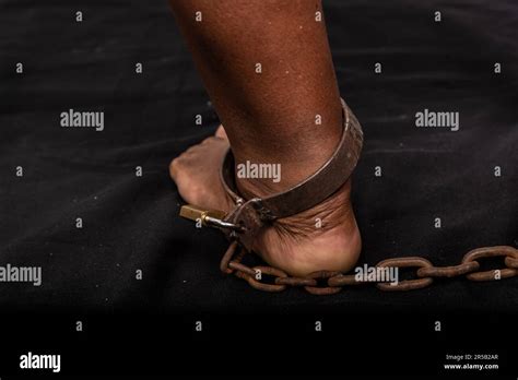Portrait Of Woman S Legs Chained With Old Rusty Metal Chain And Padlock