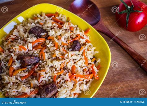 Photo Of Dish Of Uzbek Pilaf Made Of Rice And Carrots Meat And Onions