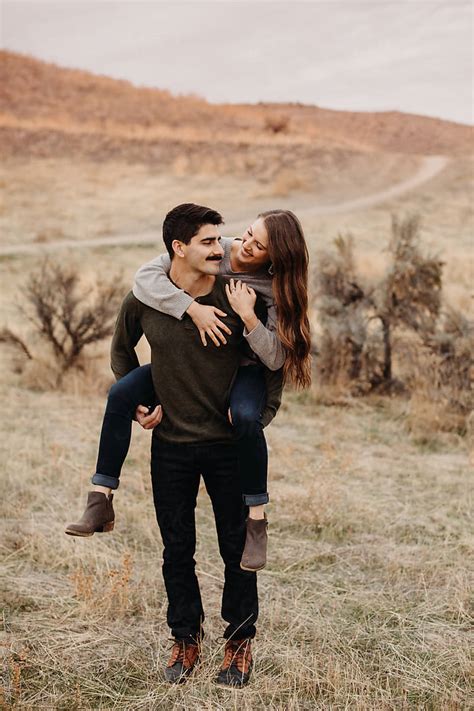 Cute Couple On Piggyback Ride By Stocksy Contributor Leah Flores