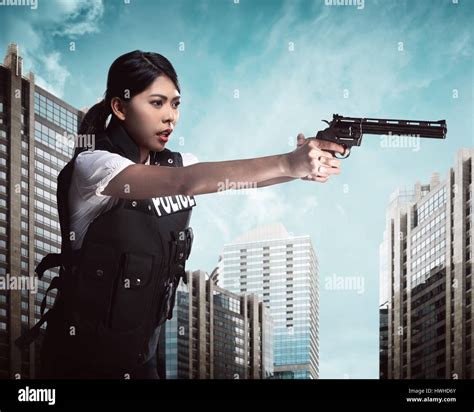 Beautiful Police Woman Holding Gun Ready To Fire Stock Photo Alamy