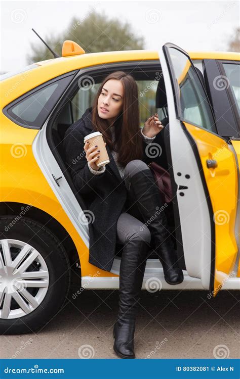 beautiful brunette coming out of yellow taxi stock image image of station door 80382081