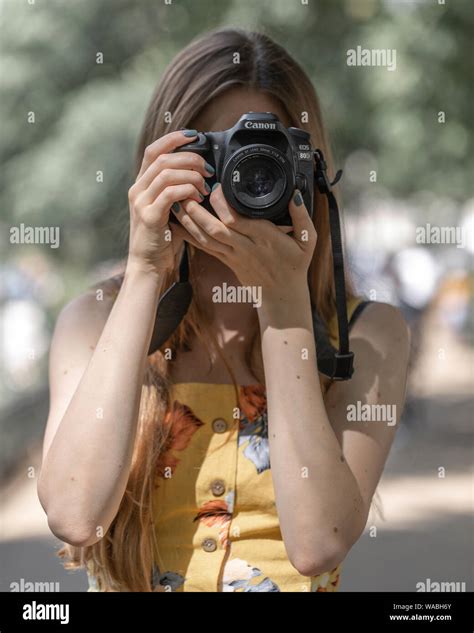 Photographer Girl Taking Pictures With Canon Camera Stock Photo Alamy